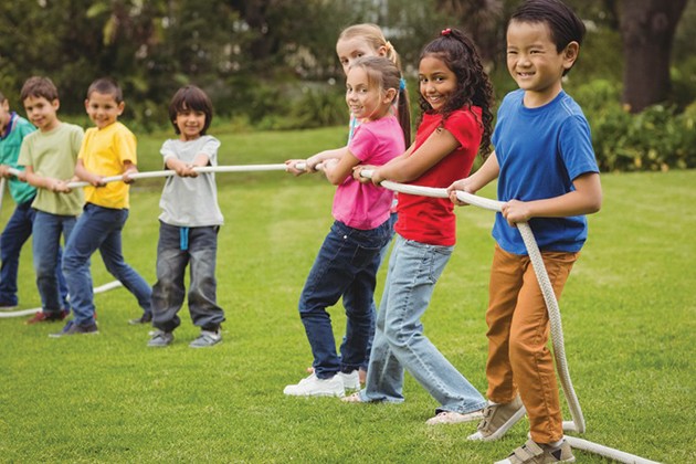 Children playing the outdoor game tug of war