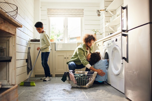 A parent teaching their children to do chores.