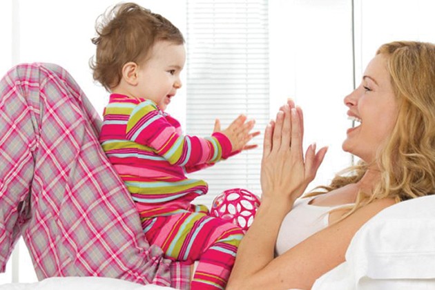 Mom and baby playing finger games together