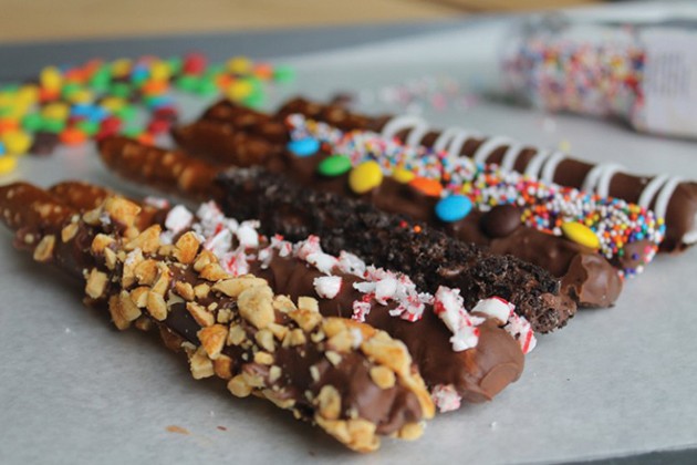 Chocolate-covered pretzels with sprinkles.