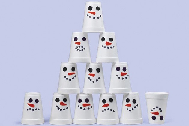 Styrofoam cups decorated like snowmen stacked in a pyramid.