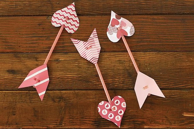 Valentine cupid arrows made from drinking straws and patterned paper.