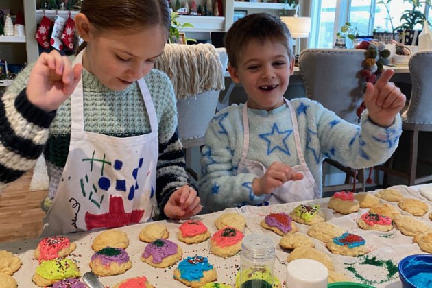 Smiling kids decorating Christmas cookies