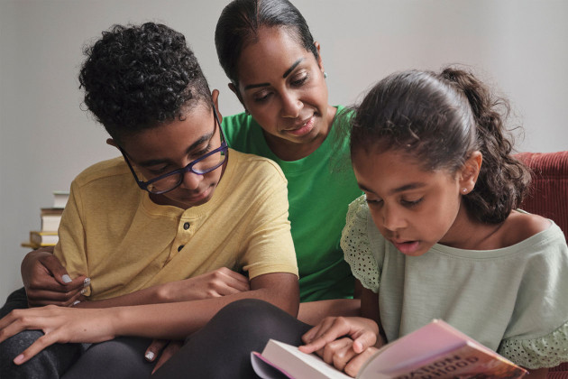 Mother reading with two children