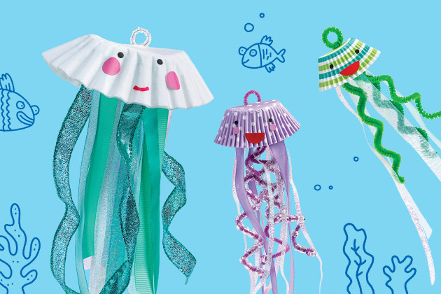 Vibrant jellyfish craft made from coffee filters and cupcake liners with tentacles made from ribbons and colorful fuzzy sticks