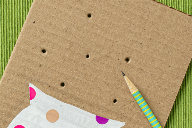 holes poked into cardboard vase with pencil for kids craft