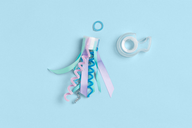 taping ribbons and fuzzy sticks for jellyfish craft step 3