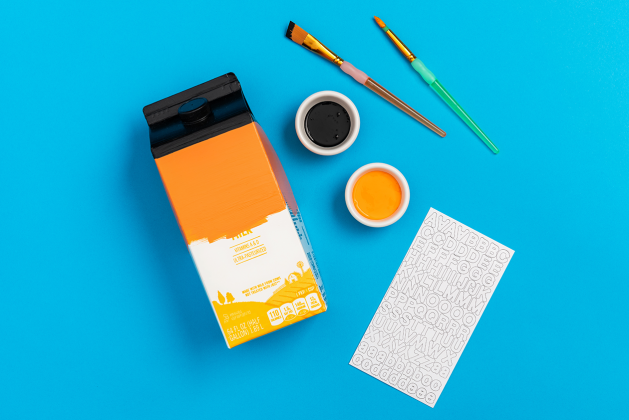 painted carton featuring paint, brushes and stickers