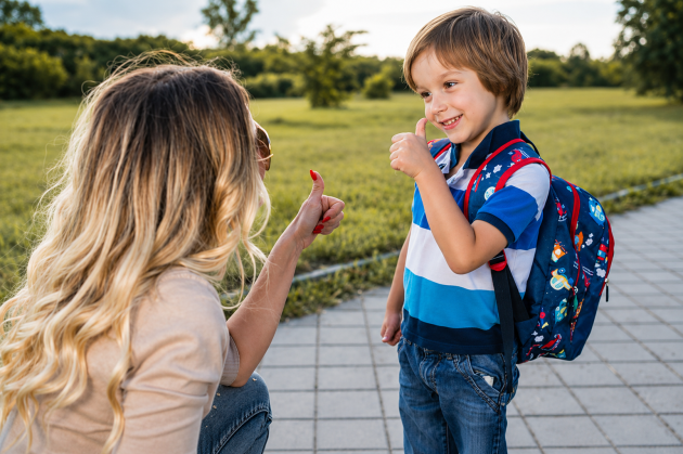 preschooler giving thumbs up to parent