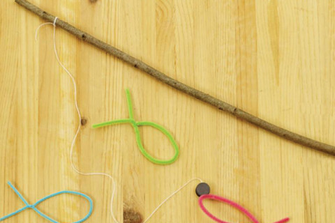 Fishing pole made from a tree branch and fish made from chenille sticks.