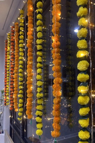 Window decorated with marigold streamers for Diwali.