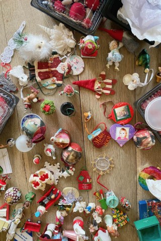 Assorted Christmas ornaments on a wood floor 